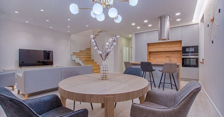 Lighting - Round Brown Wooden Table With Chairs Inside Room