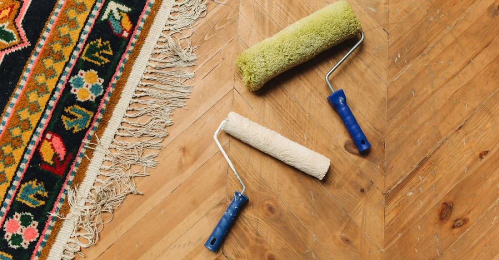 Tools - Paint Rollers Lying on a Wooden Floor 