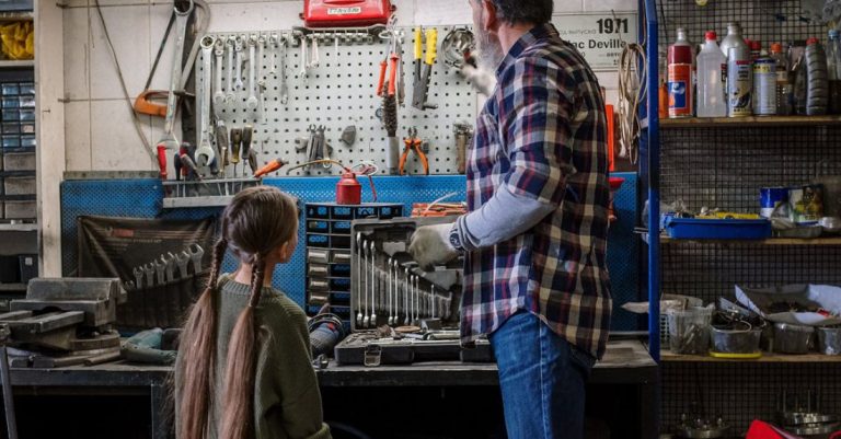 Note-Taking Tools - Back View of a Mechanic and his Daughter Looking at Tools in the Garage