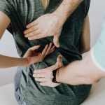 Back Pain - Doctor Examines Woman's back