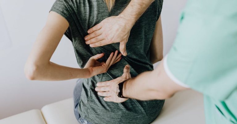 Back Pain - Doctor Examines Woman's back