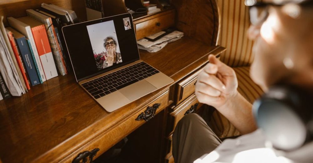 Virtual Meetings - A Person Having a Video Call on a Laptop