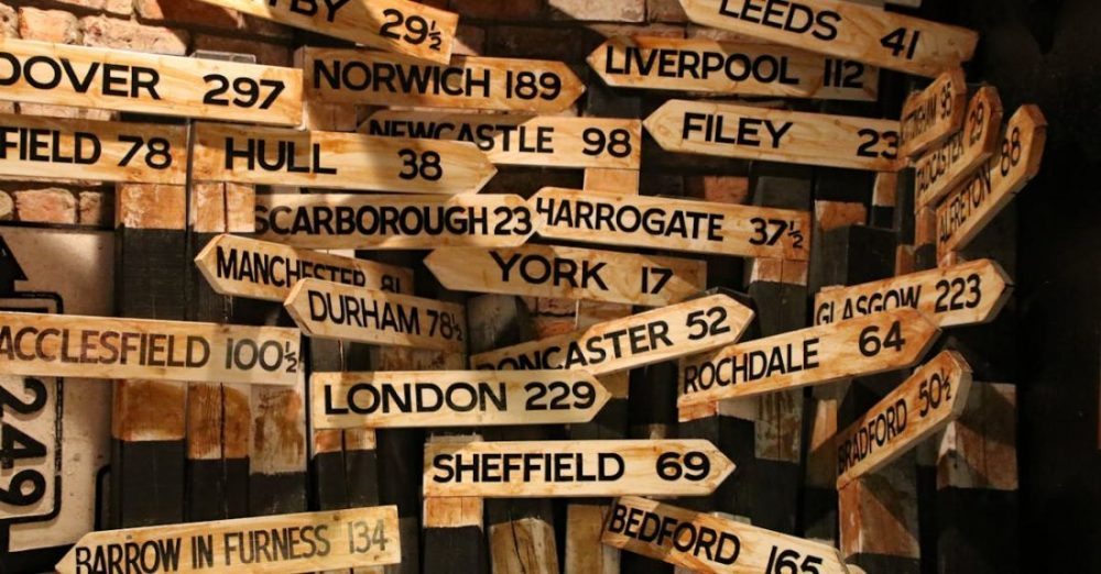 Conflict - Brown Wooden Signage Hanging Beside Wall