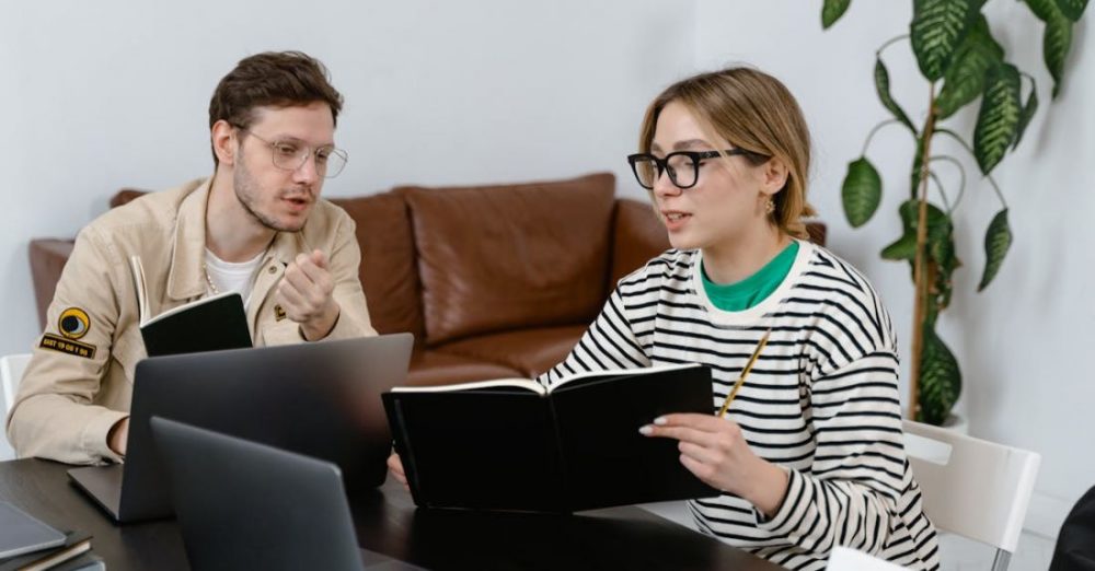 Tasks - Man and Woman Discussing in Workplace